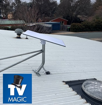 close up of a Starlink installation on a tin roof. TV Magic logo in bottom left corner.