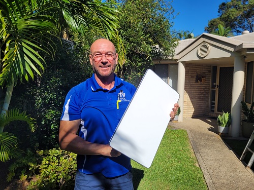 Technician holding up a Starlink dish