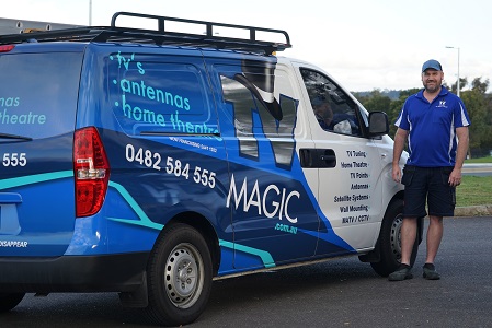 a technician standing next to his van