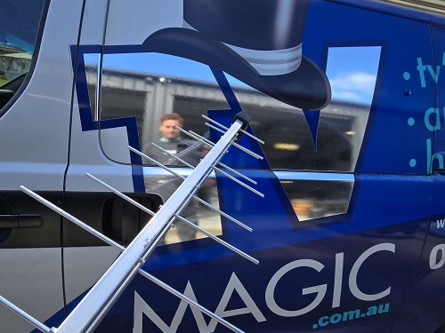 TV Magic van with antenna in front of it.