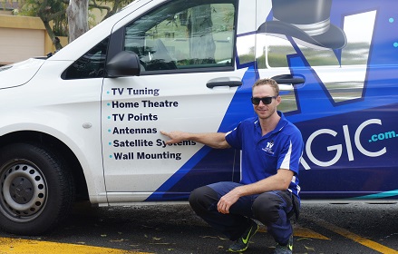 technician with his van, pointing at his services - antenna installation