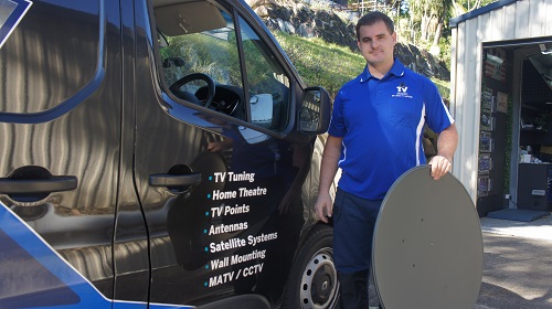 Technician holding a satellite dish ready for installation