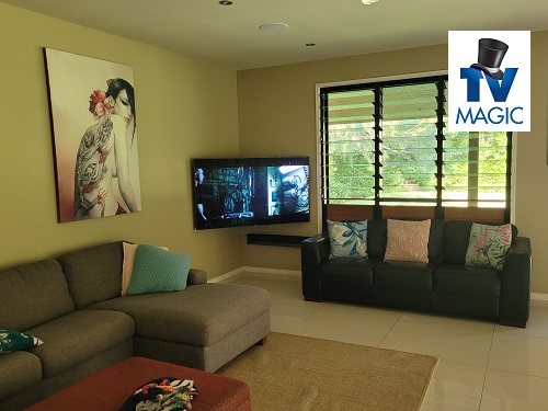 a corner TV display in a living room. TV Magic logo in top right corner