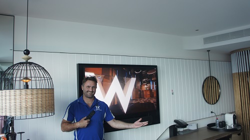 Technician showcasing a TV wall mounting job