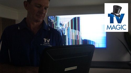 Technician in front of a broken TV.