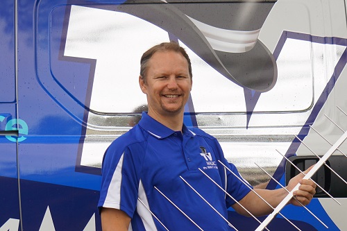 technician - Jason, next to his van, holding an antenna