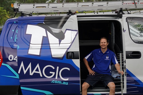 Technician Jason, seated in the side of his van.