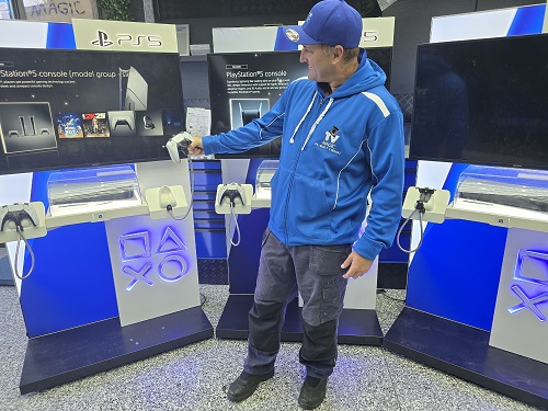 Technician with a commercial gaming console setup