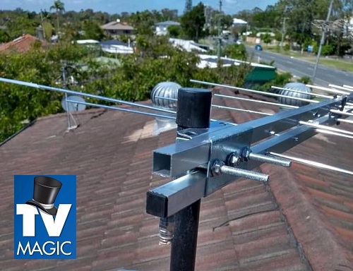 A close up of an antenna installation on a tile roof. TV Magic logo included