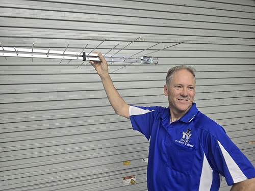 Technician holding up an antenna
