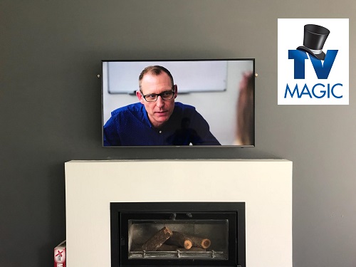 TV above fireplace by TV Magic.