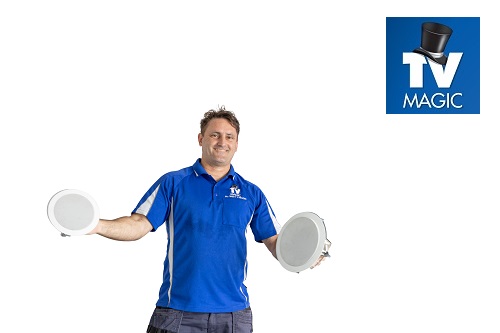 Technician holding up speakers