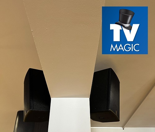 speakers on wall with TV Magic logo