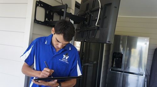 Technician performing a TV insurance repair assessment