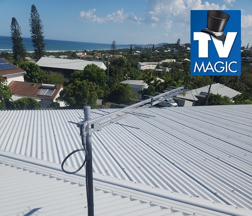 close up of an antenna installed on a tin roof with TV Magic logo