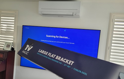 a wall mounted TV with a large TV Magic wall bracket in front of it