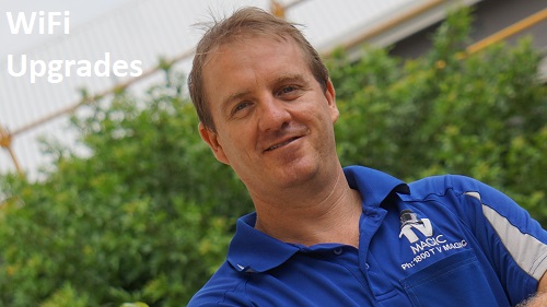 A technician - Brent, with the caption "WiFi Upgrades" in top left corner