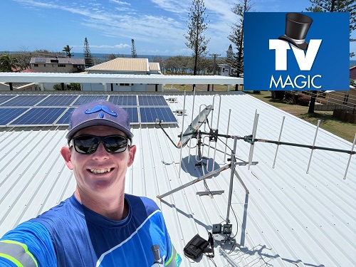 Technician showing off an antenna installation he completed in Dean Park
