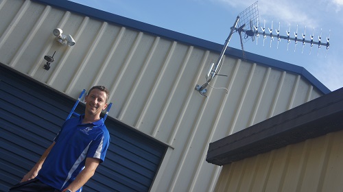 Technician Jim with an antenna he installed.