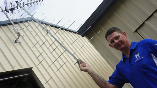 Technician holding up an antenna