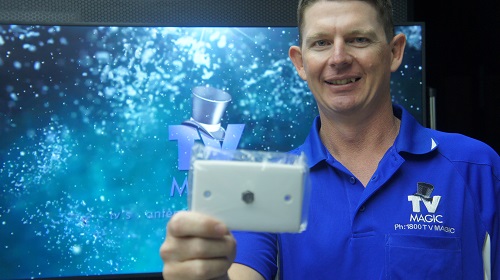 Technician in front of TV holding TV point.