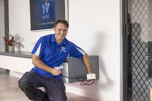 Technician holding a TV point in living room