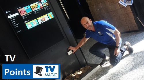 technician holding a TV point up to a wall. Caption in bottom left corner "TV Points". TV Magic logo next to caption