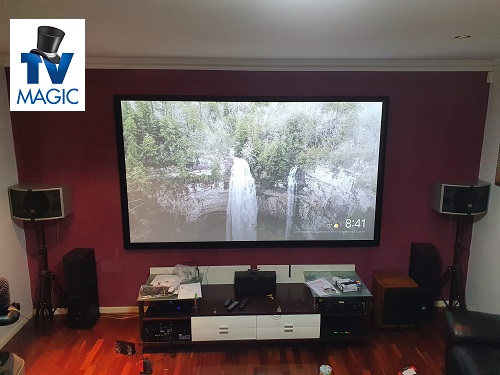 a complete home cinema installation, with a TV Magic logo in top left corner