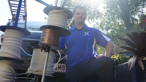 Technician with rolls of cabling, ready for a pre-wire fit out