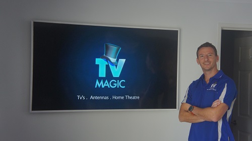 Jim with a TV in the background with a TV Magic logo on it