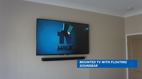 sound bar mounted on the wall with a wall mounted TV