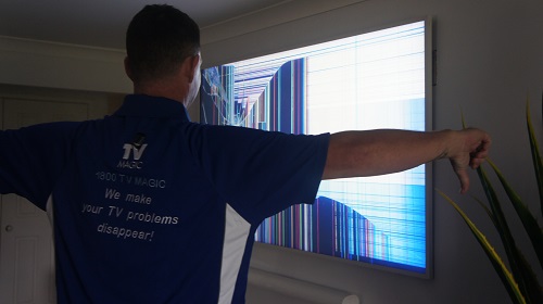 Technician with a broken TV