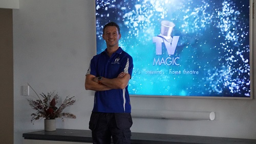 Technician in front of a home theatre setup