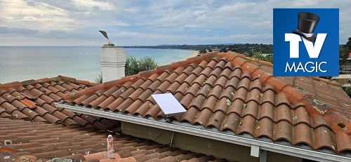 A TV Magic Starlink internet installation on a tile roof. TV Magic logo in top right corner