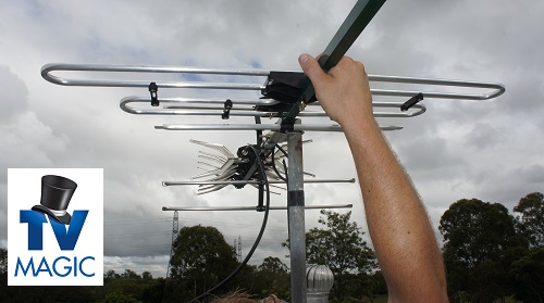 close up of technician holding antenna. TV Magic logo in bottom left corner